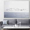 Beach and coastal wall art print of Seagull Flock on a stretched canvas displayed in a room
