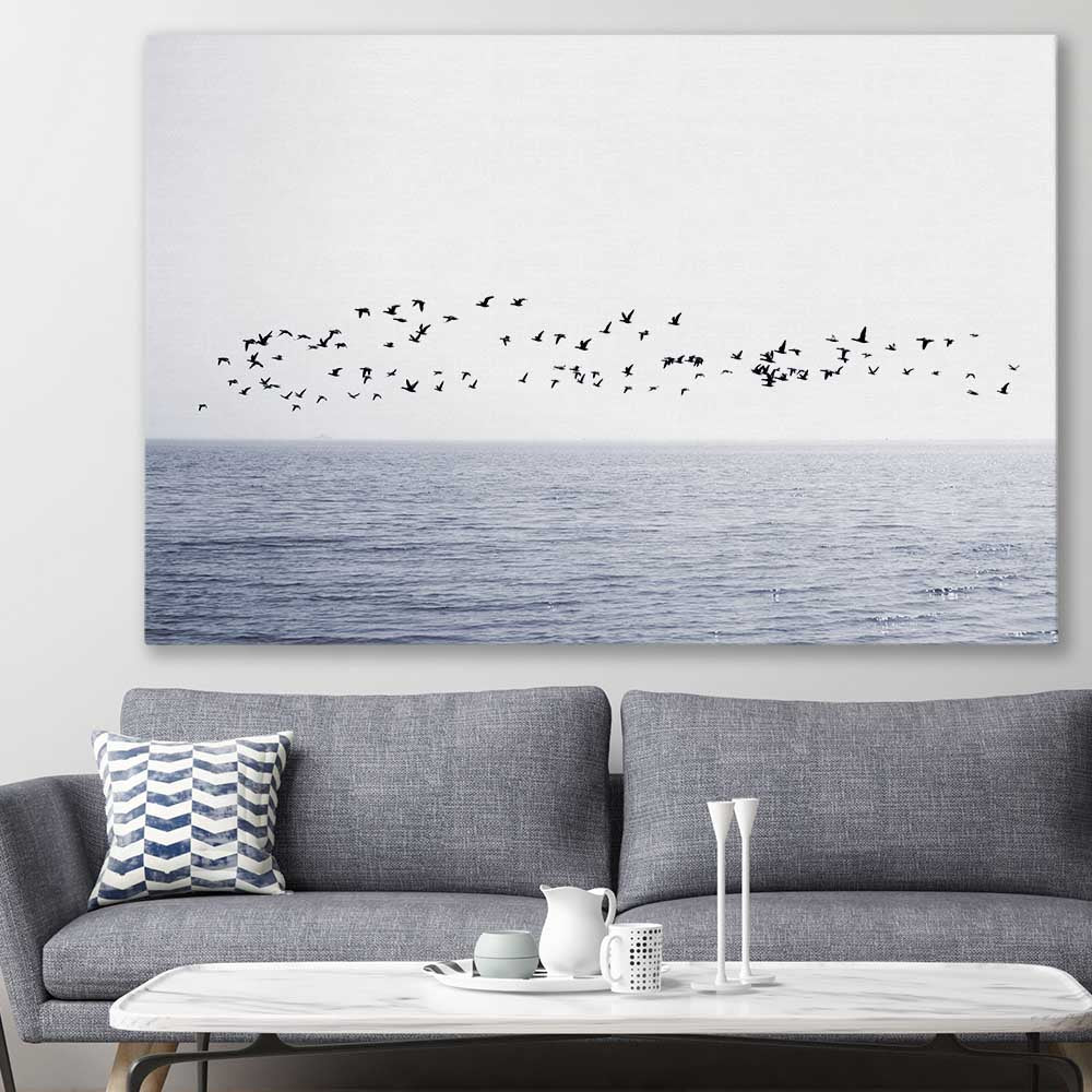 Beach and coastal wall art print of Seagull Flock on a stretched canvas displayed in a room