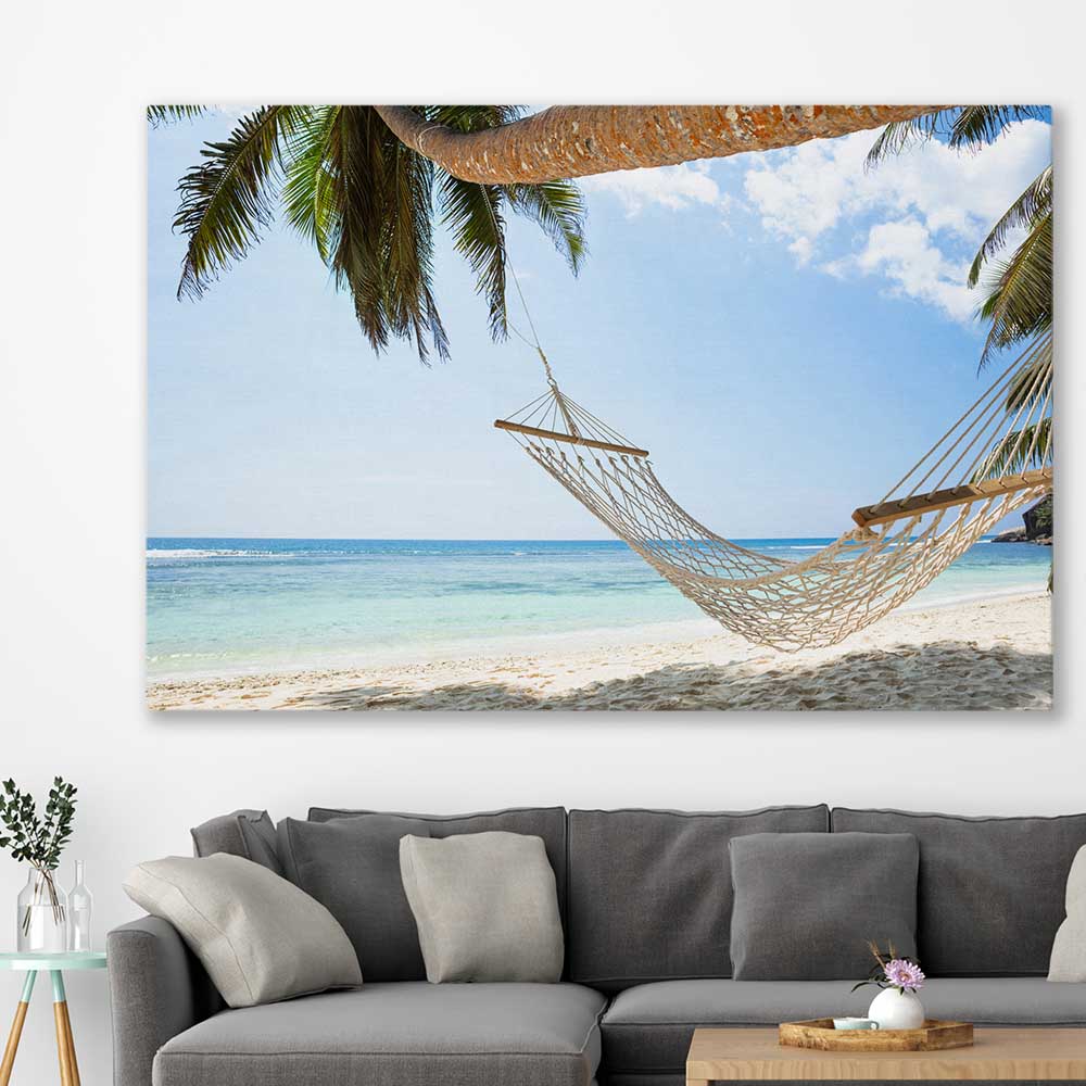 Beach and coastal wall art print of Seychelles Hammock on a stretched canvas displayed in a room
