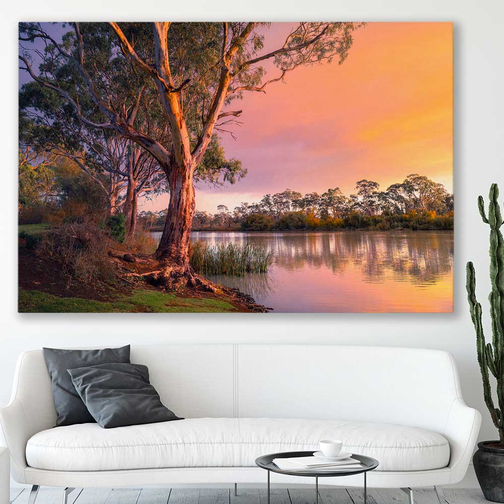 Floral print of Blissful River Sunset on a stretched canvas displayed in a room