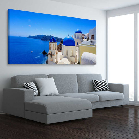 Beach and coastal wall art print of Santorini Cliffside on a stretched canvas displayed from an angle in a room