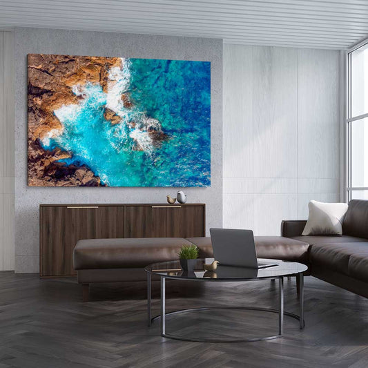 Beach and coastal wall art print of Azure Blue Sea on a stretched canvas displayed from an angle in a room