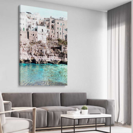 Beach and coastal wall art print of Polignano a Mare on a stretched canvas displayed from an angle in a room