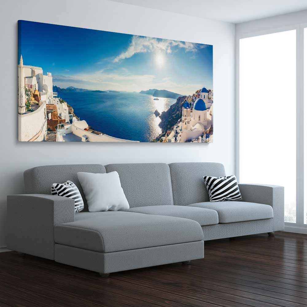 Beach and coastal wall art print of Santorini Panorama on a stretched canvas displayed from an angle in a room