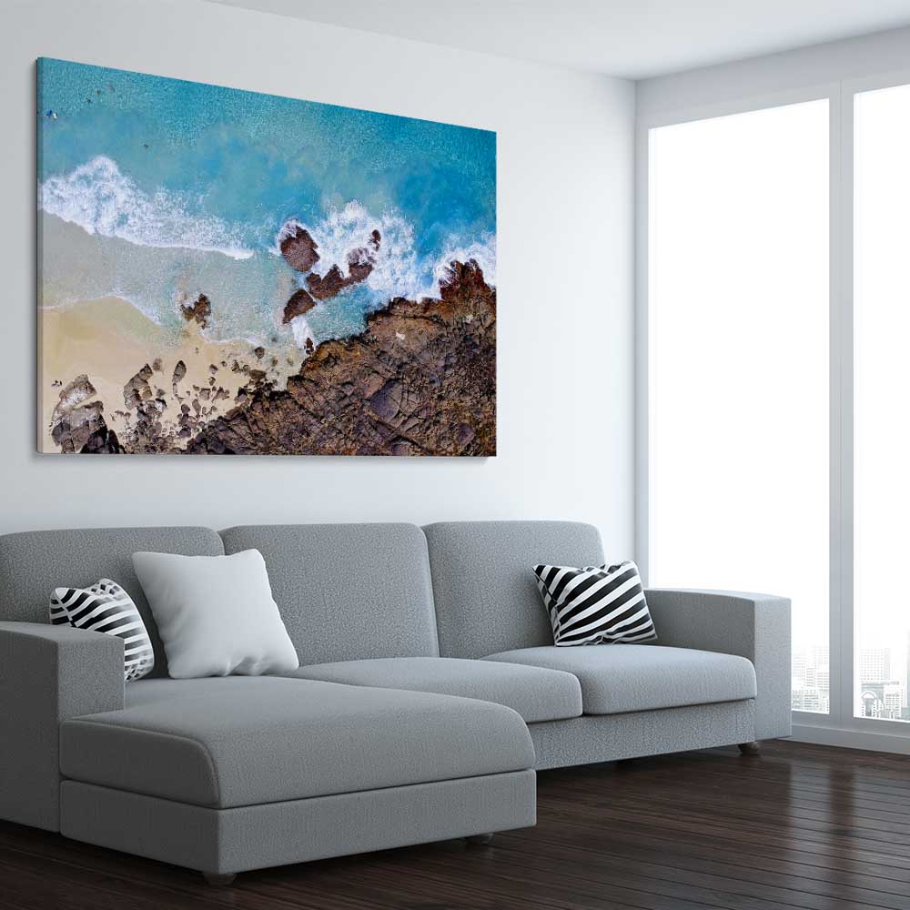 Beach and coastal wall art print of Smiths Beach on a stretched canvas displayed from an angle in a room