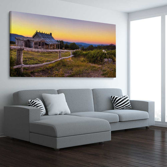 Floral print of Craigs Hut at Sunset on a stretched canvas displayed from an angle in a room