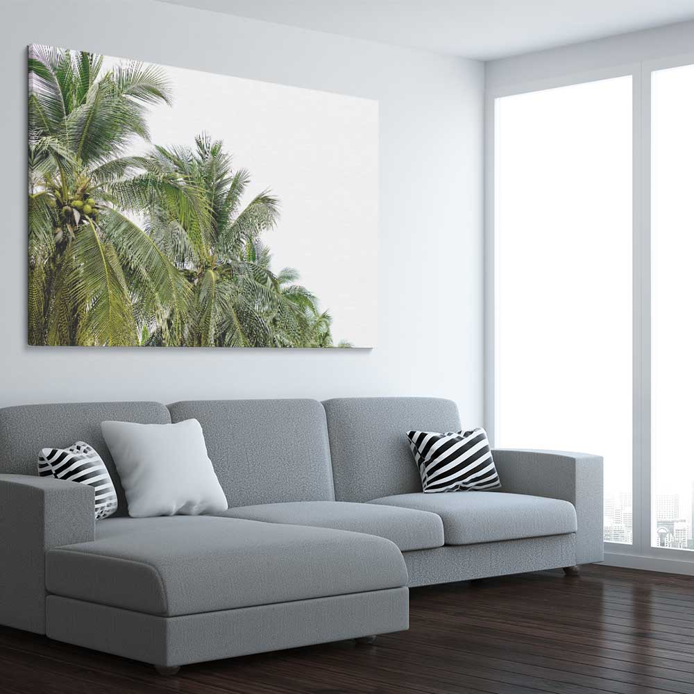 Floral print of Coconut Palms on a stretched canvas displayed from an angle in a room