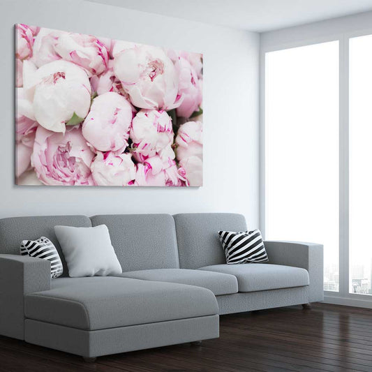 Floral print of Delicate Peonies on a stretched canvas displayed from an angle in a room