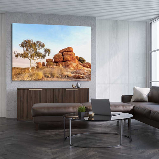Floral print of Devils Marbles on a stretched canvas displayed from an angle in a room