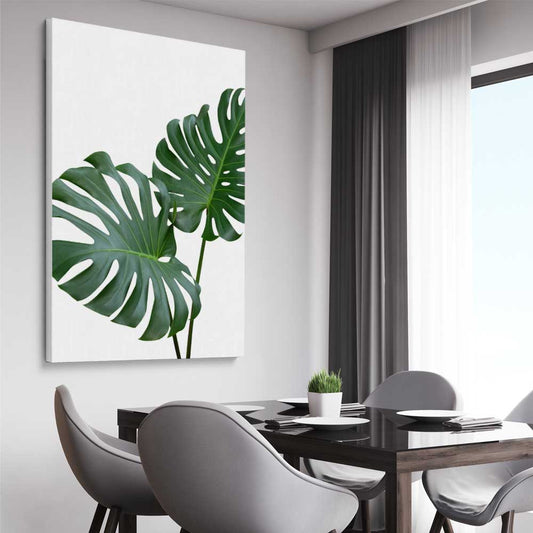 Floral print of Monstera Leaf One on a stretched canvas displayed from an angle in a room