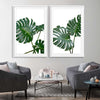 Floral print of Monstera Leaf Pair on a stretched canvas displayed from an angle in a room
