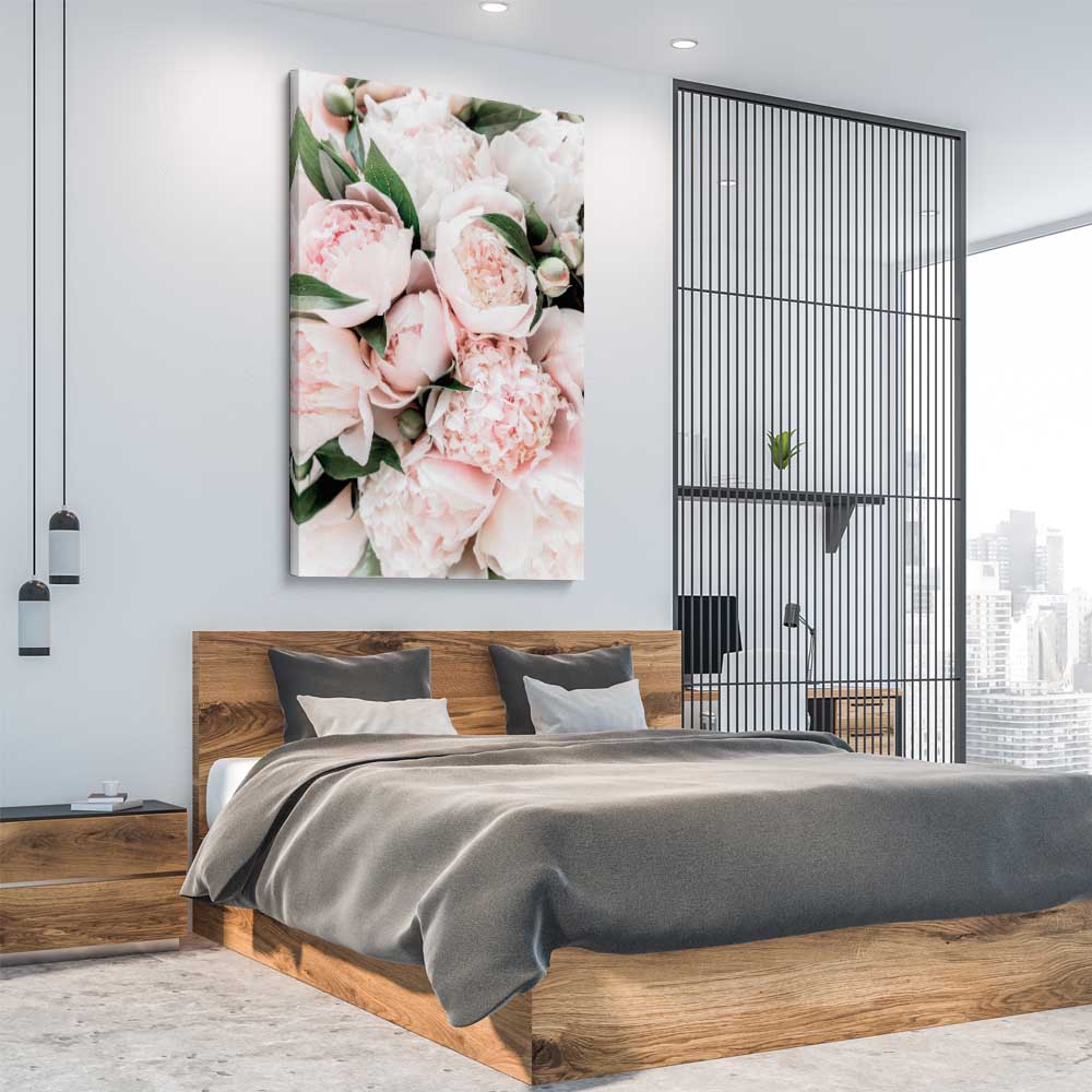 Floral print of Pink Peonies on a stretched canvas displayed from an angle in a room