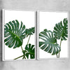 Floral print of Monstera Leaf Pair with white framed canvas