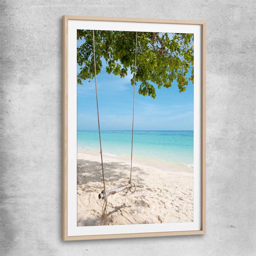 Beach and coastal wall art print of Pristine Beach Swing with raw oak glass front frame