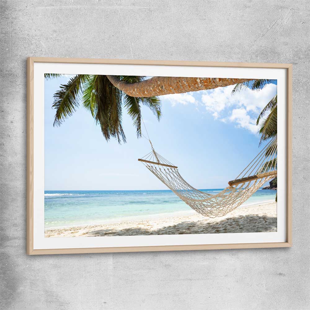 Beach and coastal wall art print of Seychelles Hammock with raw oak glass front frame