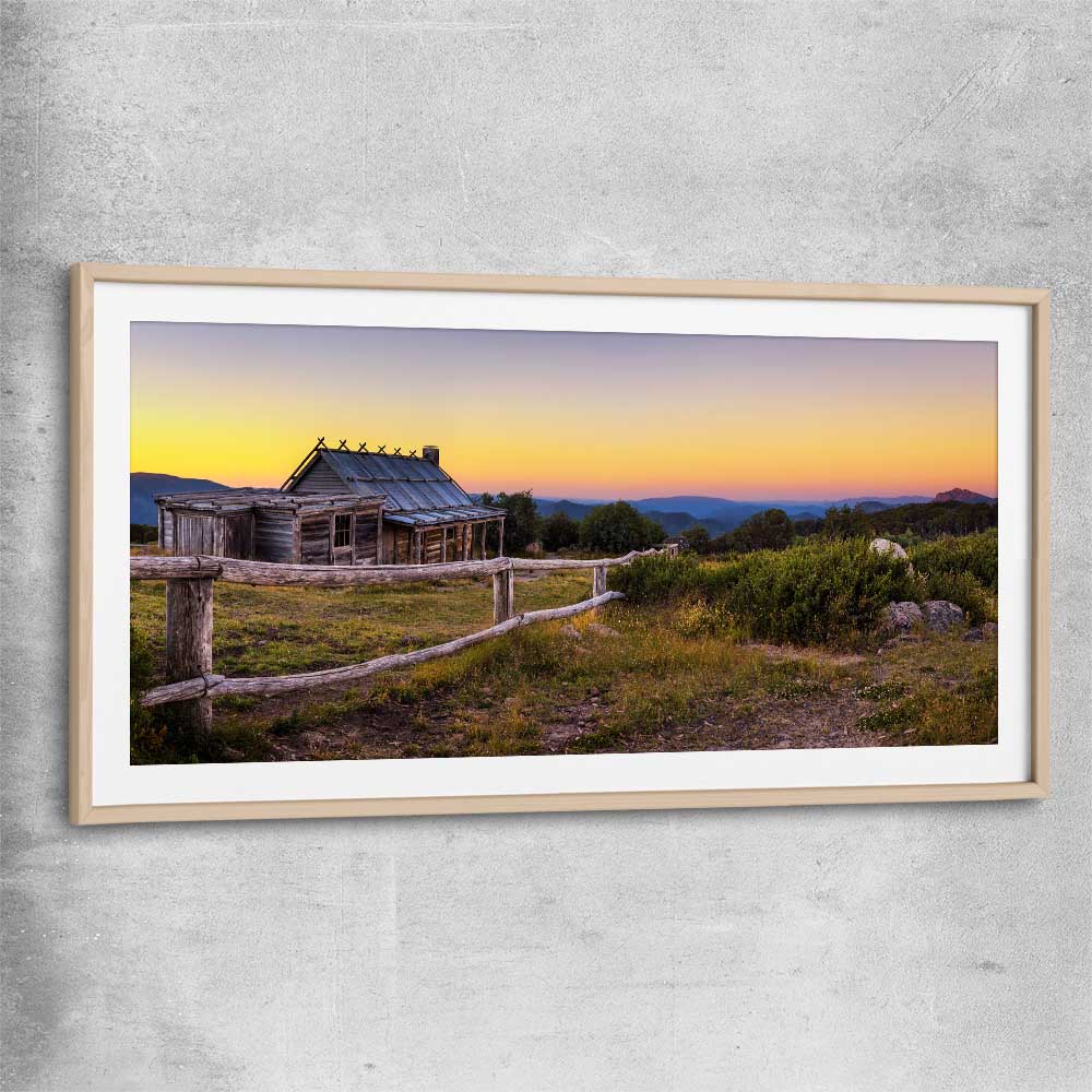 Floral print of Craigs Hut at Sunset with raw oak glass front frame