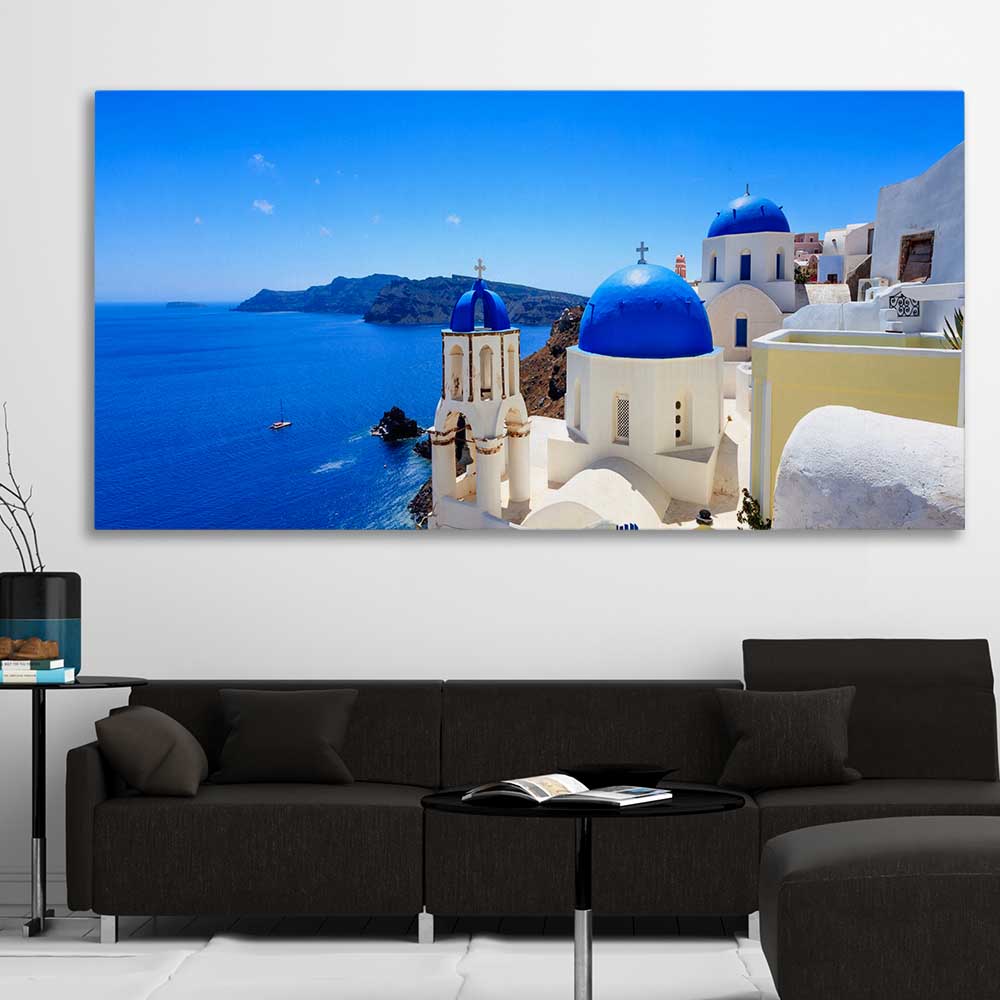 Beach and coastal wall art print of Santorini Cliffside on a stretched canvas displayed in a room