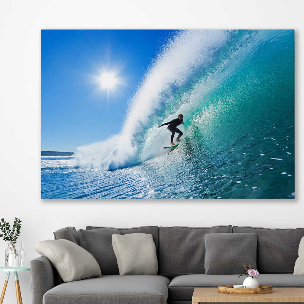 Beach and coastal wall art print of Blue Ocean Surfer on a stretched canvas displayed in a room