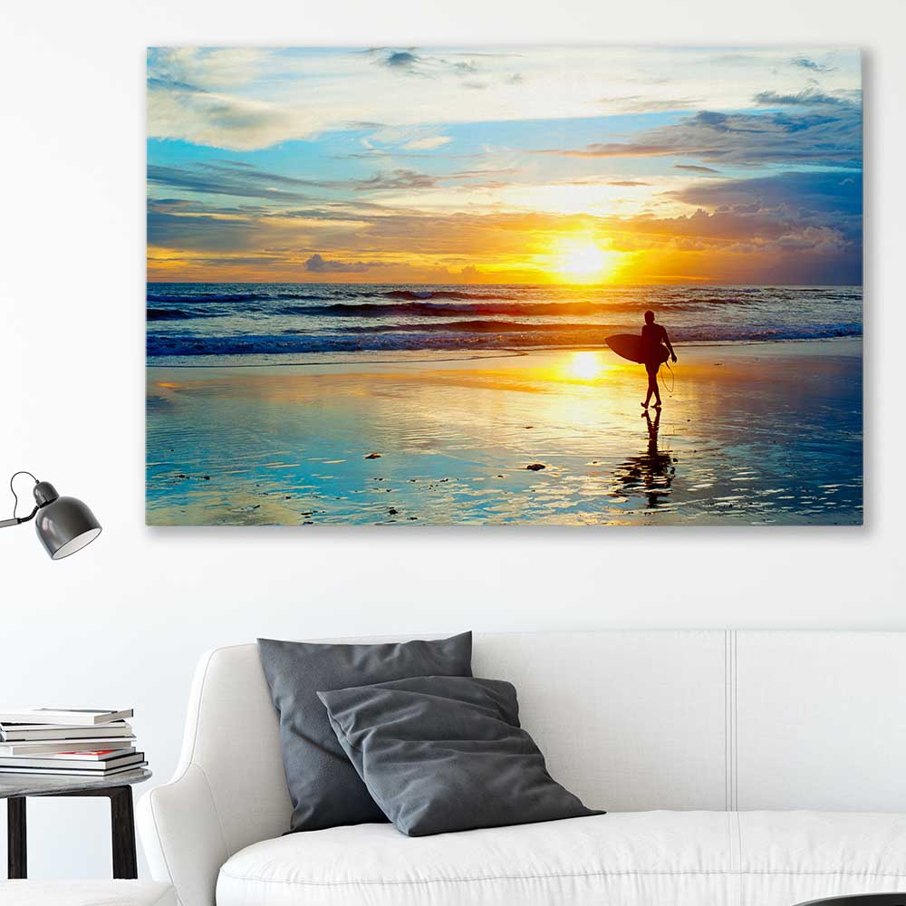Beach and coastal wall art print of Last Surf at Sunset on a stretched canvas displayed in a room