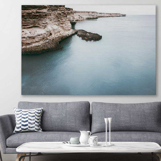 Beach and coastal wall art print of Quiet Waters on a stretched canvas displayed in a room