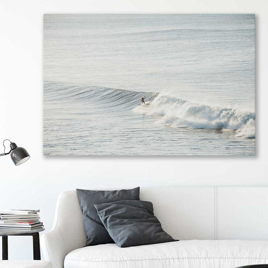 Beach and coastal wall art print of Surfing Waves on a stretched canvas displayed in a room