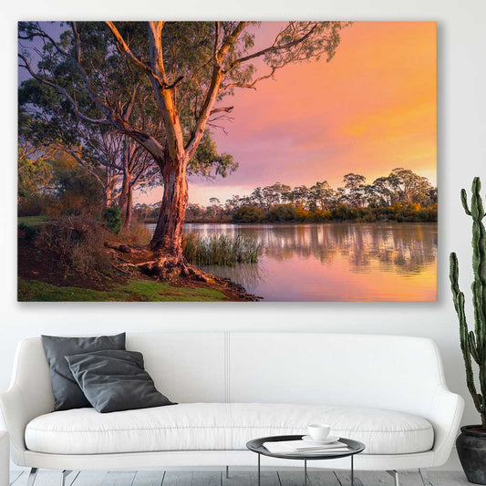 Floral print of Blissful River Sunset on a stretched canvas displayed in a room
