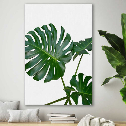 Floral print of Monstera Leaf Two on a stretched canvas displayed in a room