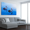 Animal wall art and canvas prints of Pelican Blue Waters on a stretched canvas displayed from an angle in a room