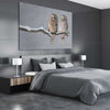 Animal wall art and canvas prints of Perched Owls on a stretched canvas displayed from an angle in a room