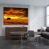 Animal wall art and canvas prints of Savannah Elephant Sunset on a stretched canvas displayed from an angle in a room