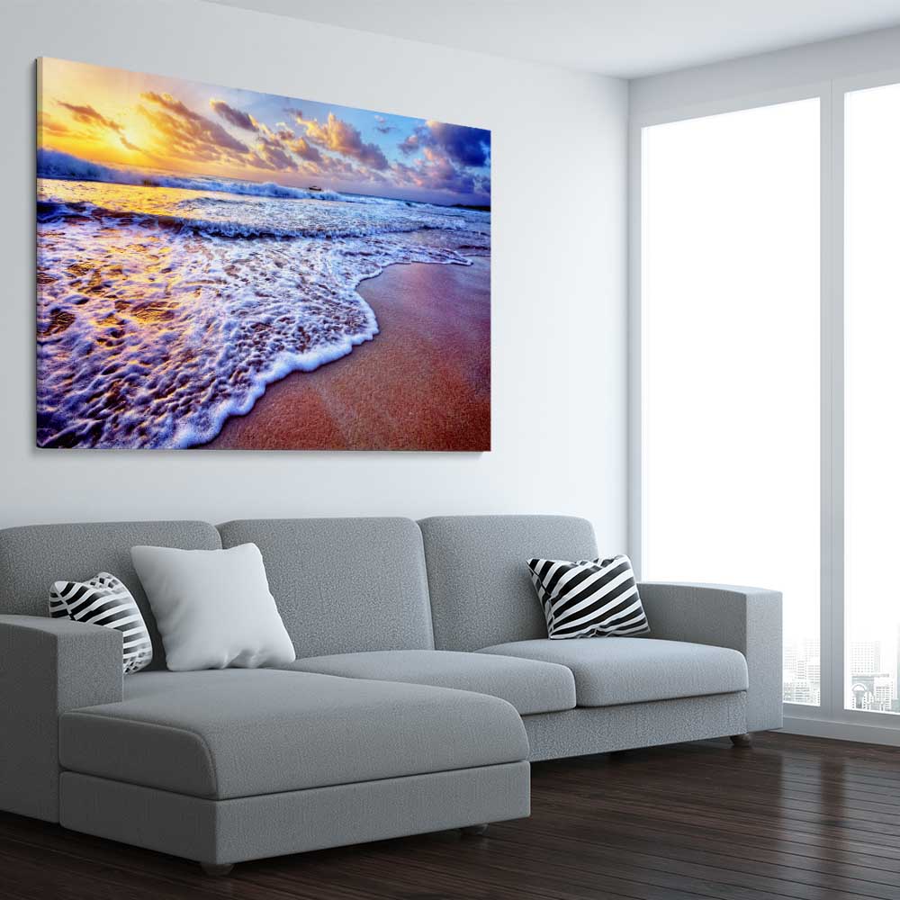 Beach and coastal wall art print of Sunset Coastal Glow on a stretched canvas displayed from an angle in a room