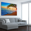 Beach and coastal wall art print of Tropical Sunset Shore on a stretched canvas displayed from an angle in a room