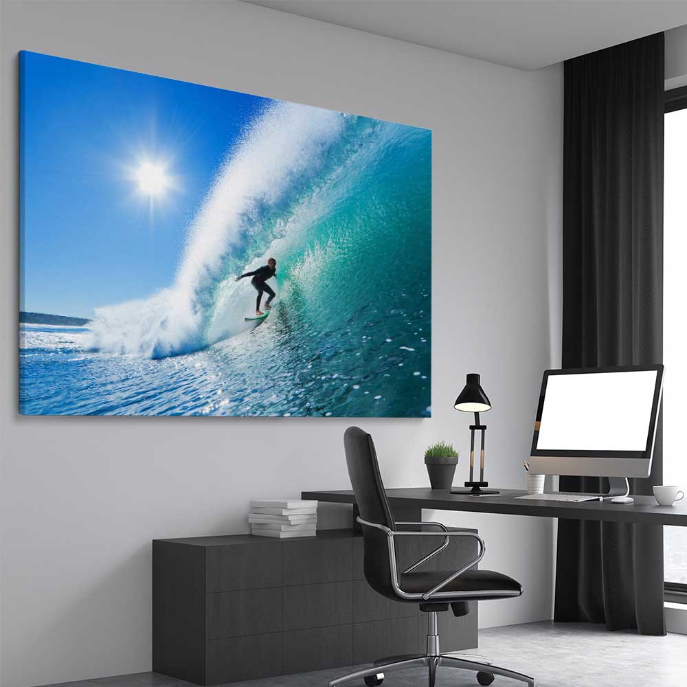 Beach and coastal wall art print of Blue Ocean Surfer on a stretched canvas displayed from an angle in a room