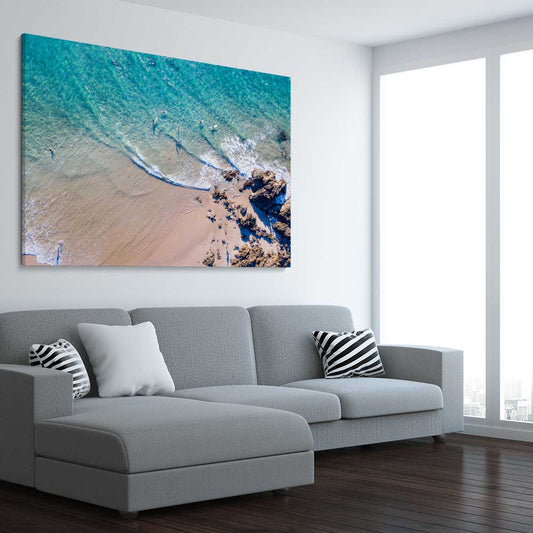 Beach and coastal wall art print of Byron Bay Rocks on a stretched canvas displayed from an angle in a room