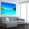 Beach and coastal wall art print of Serene Island Waters on a stretched canvas displayed from an angle in a room