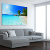 Beach and coastal wall art print of Seychelles Crystal Water on a stretched canvas displayed from an angle in a room