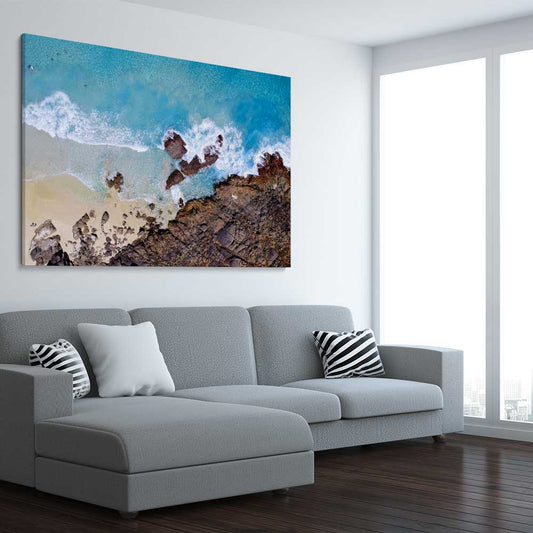 Beach and coastal wall art print of Smiths Beach on a stretched canvas displayed from an angle in a room
