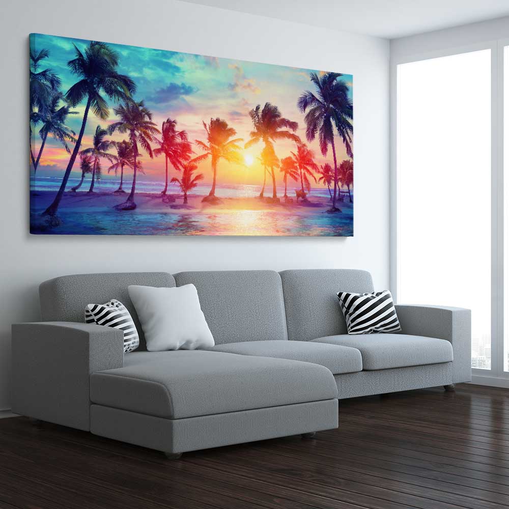 Beach and coastal wall art print of Sunset Palm Glow on a stretched canvas displayed from an angle in a room