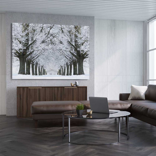 Floral print of Winter Tree Avenue on a stretched canvas displayed from an angle in a room