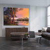 Floral print of Blissful River Sunset on a stretched canvas displayed from an angle in a room
