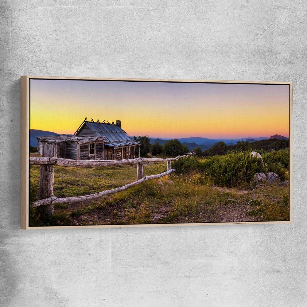 Floral print of Craigs Hut at Sunset with raw oak framed canvas