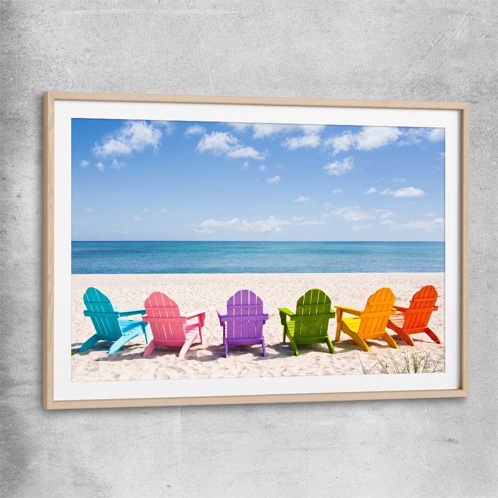 Beach and coastal wall art print of Pastel Chairs with raw oak glass front frame
