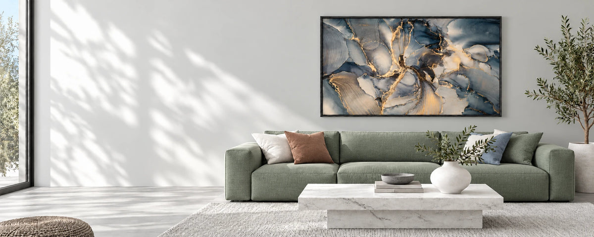Printivart Fluid Swirls in a matte black frame above a grey sofa in a living room with soft daylight